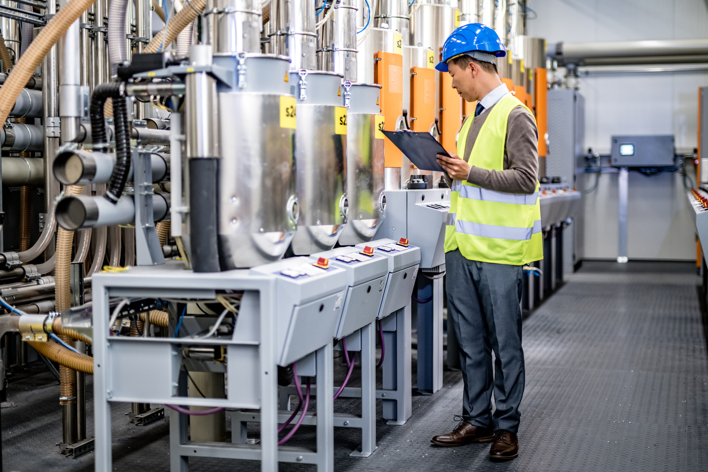 Engineer examining manufacturing machinery